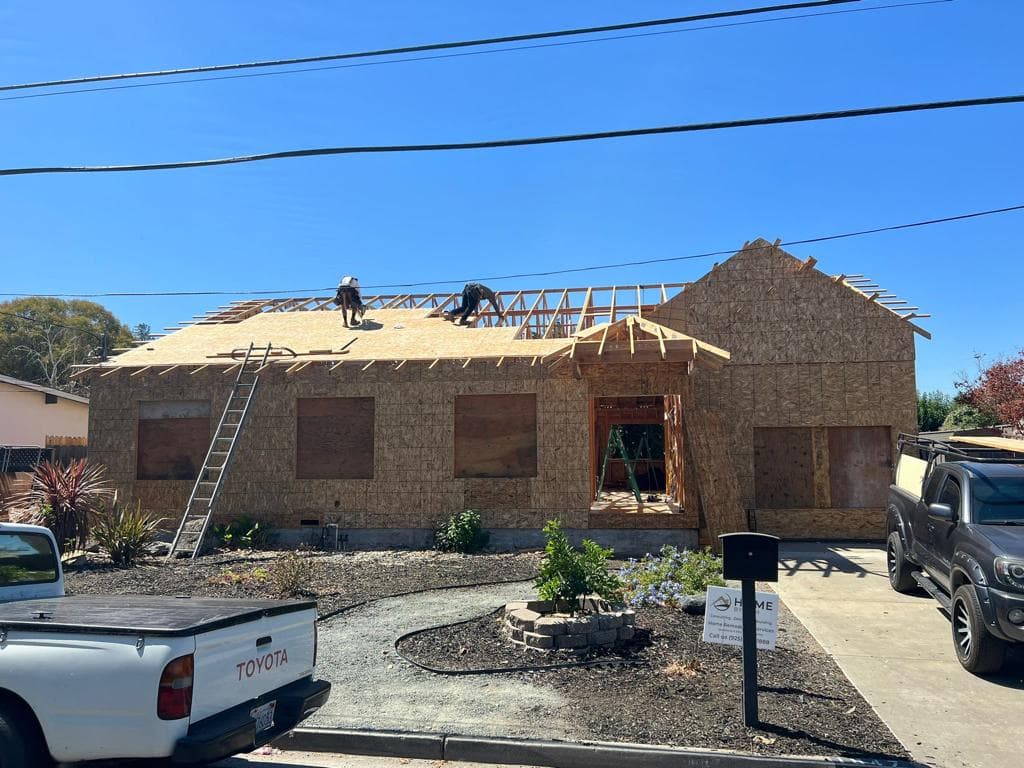 New-construction house being sheathed and roofed