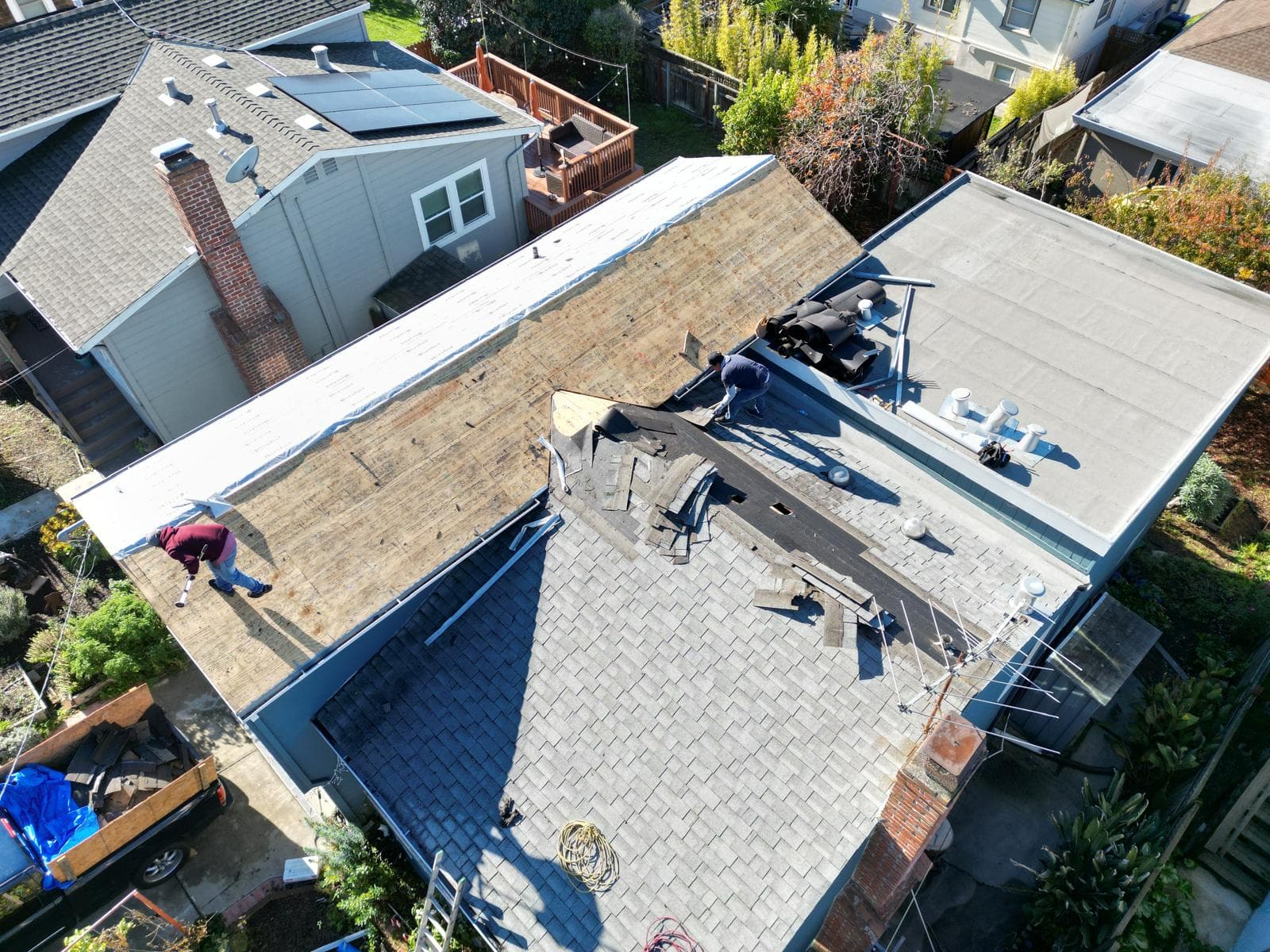 Residential roof replacement with decking exposed and underlayment going down