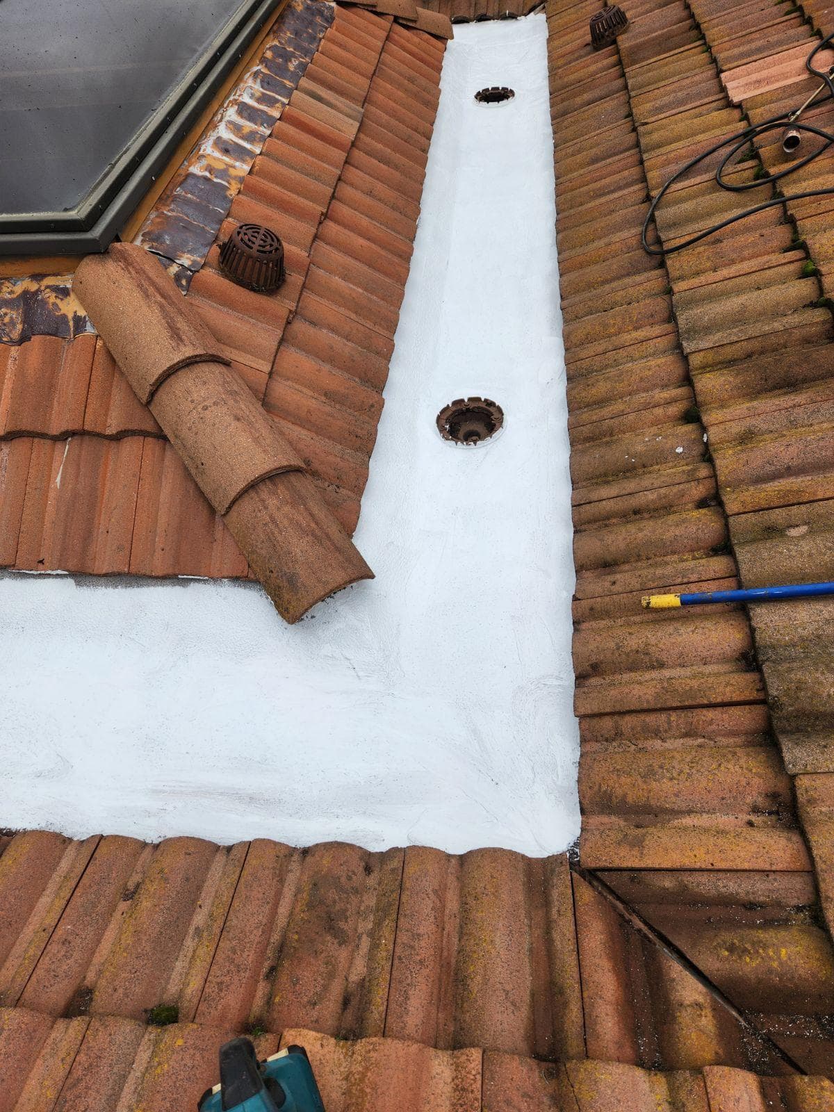 Waterproof coating applied in a terracotta tile roof valley